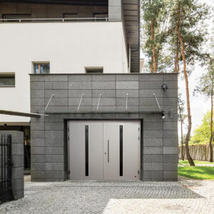 Ryterna side hinged modern style garage door installed in a concrete block garage