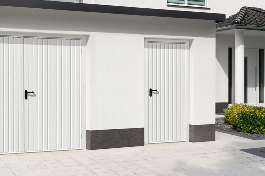 personnel garage door installed to modern white garage